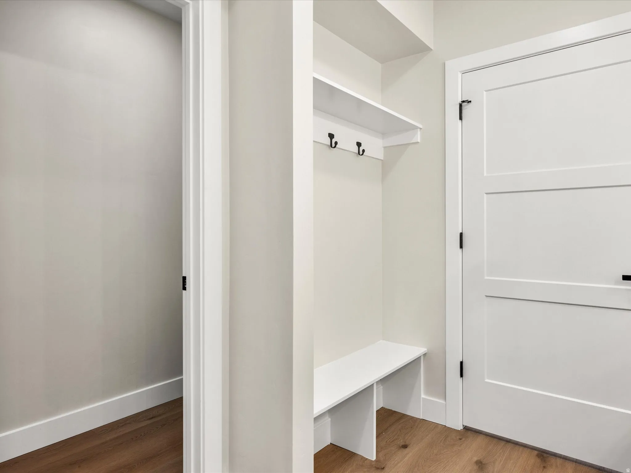 Built-in bench and shelving unit with coat hooks