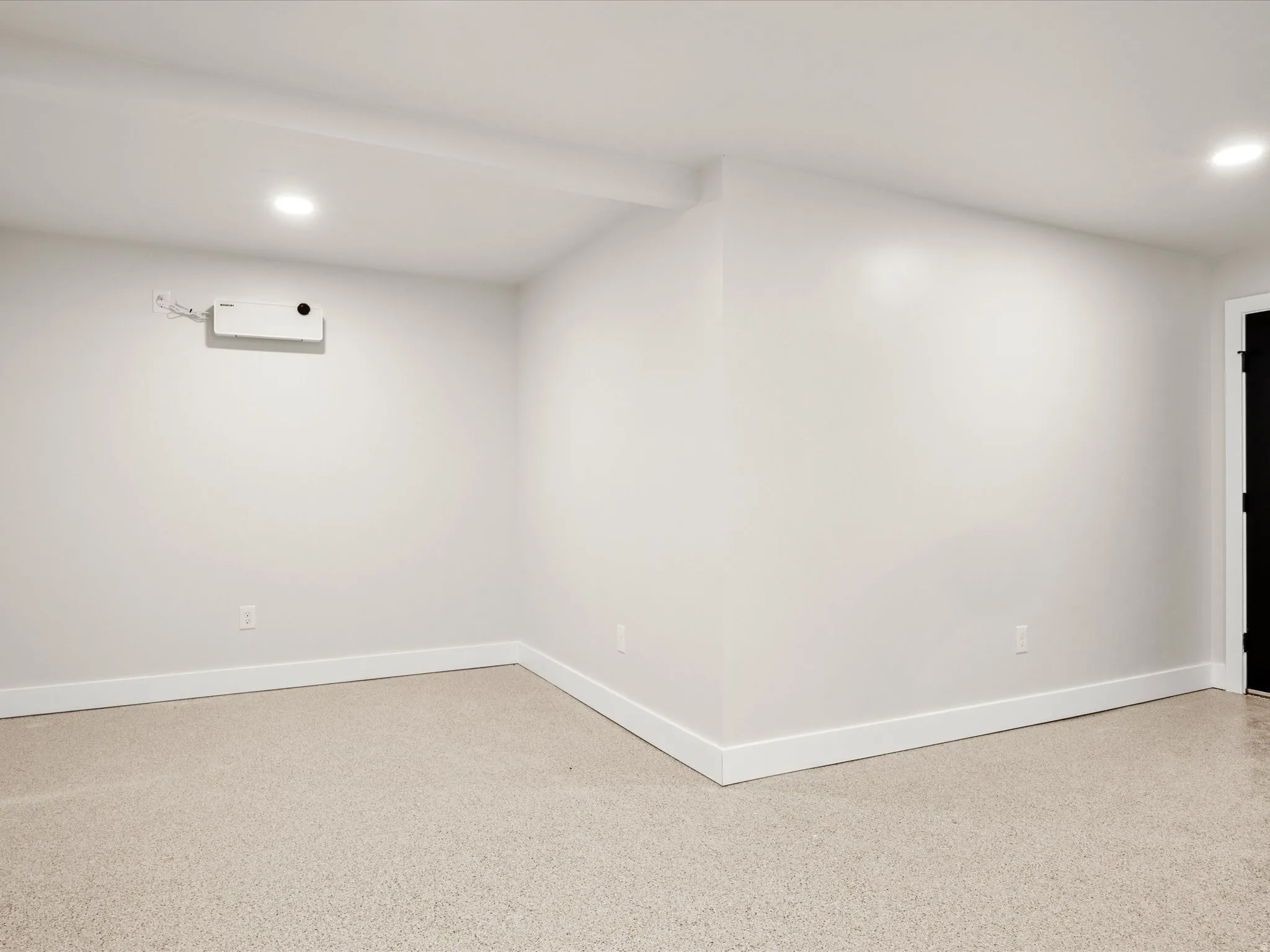 Carpeted room featuring white walls, recessed lighting, and white baseboards