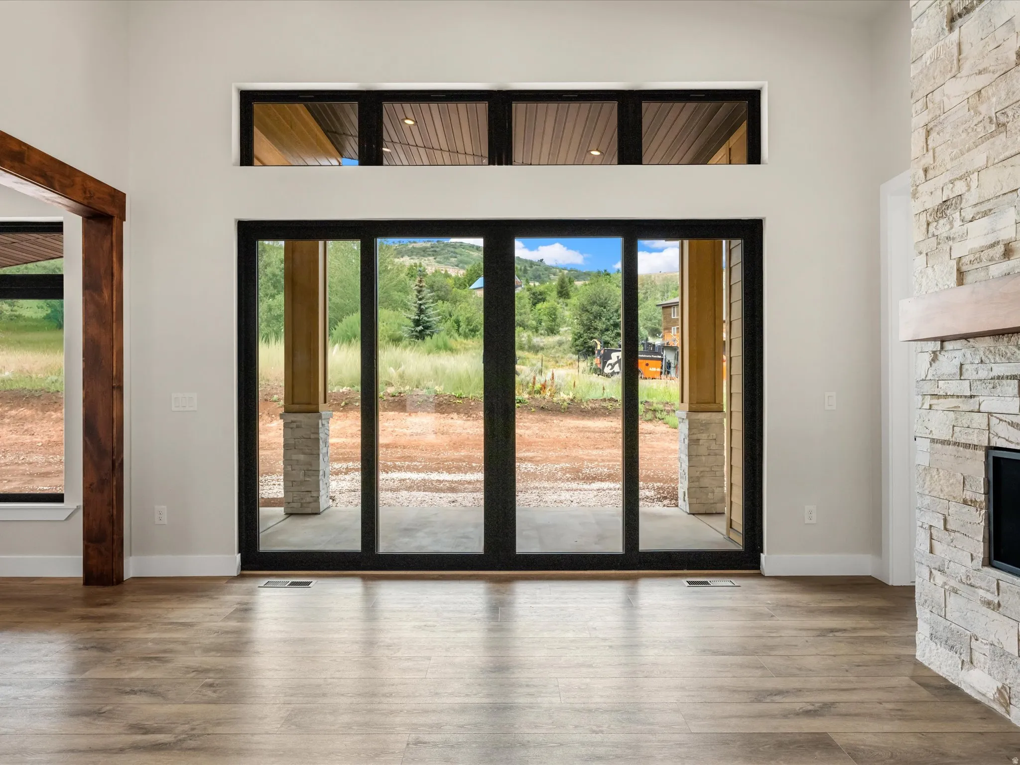 Expansive sliding glass doors with transom windows