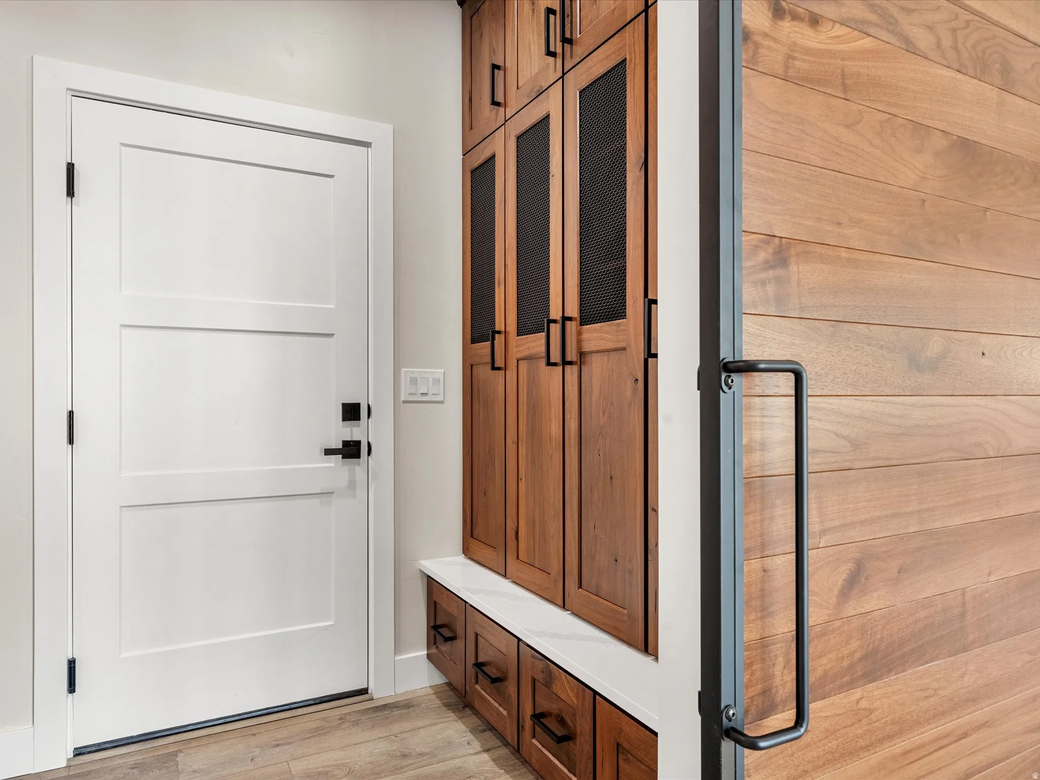 White paneled door with black hardware