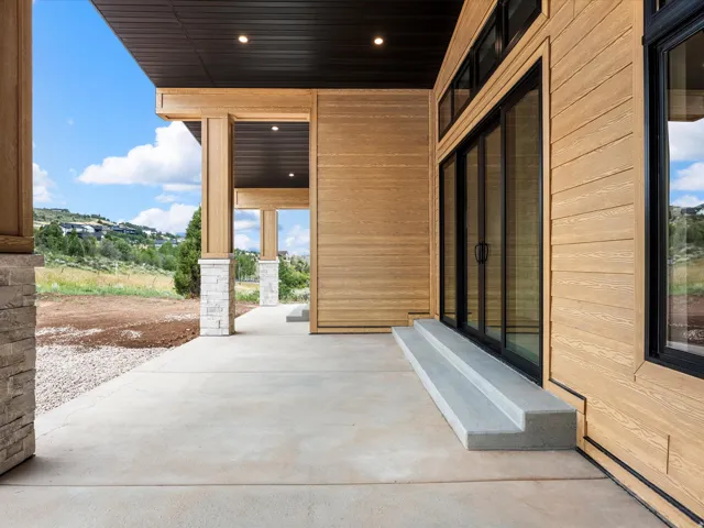Expansive concrete patio with integrated steps and a wood-finish exterior