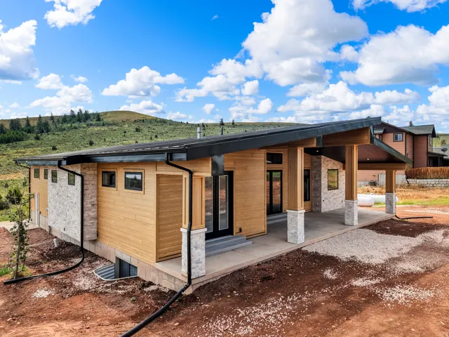 Modern exterior featuring natural wood siding and stone accents