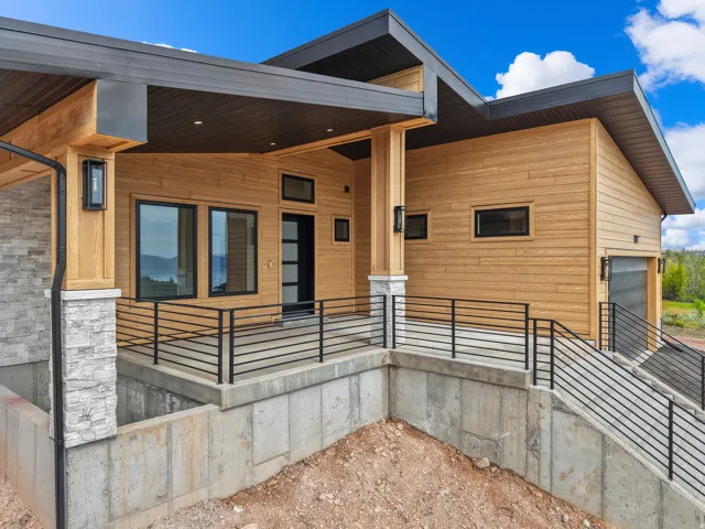 Modern exterior showcasing light wood-finish siding and dark trim accents