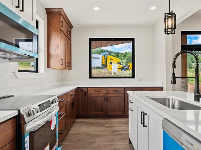 Modern kitchen featuring wood-finish flooring and white walls
