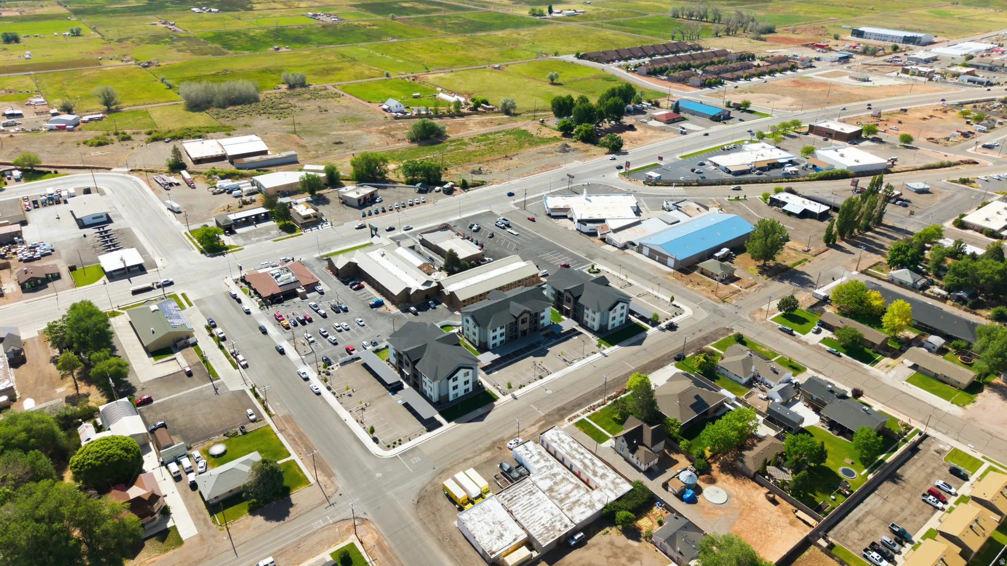 Aerial perspective showcasing a mixed-use area with residential structures and commercial buildings