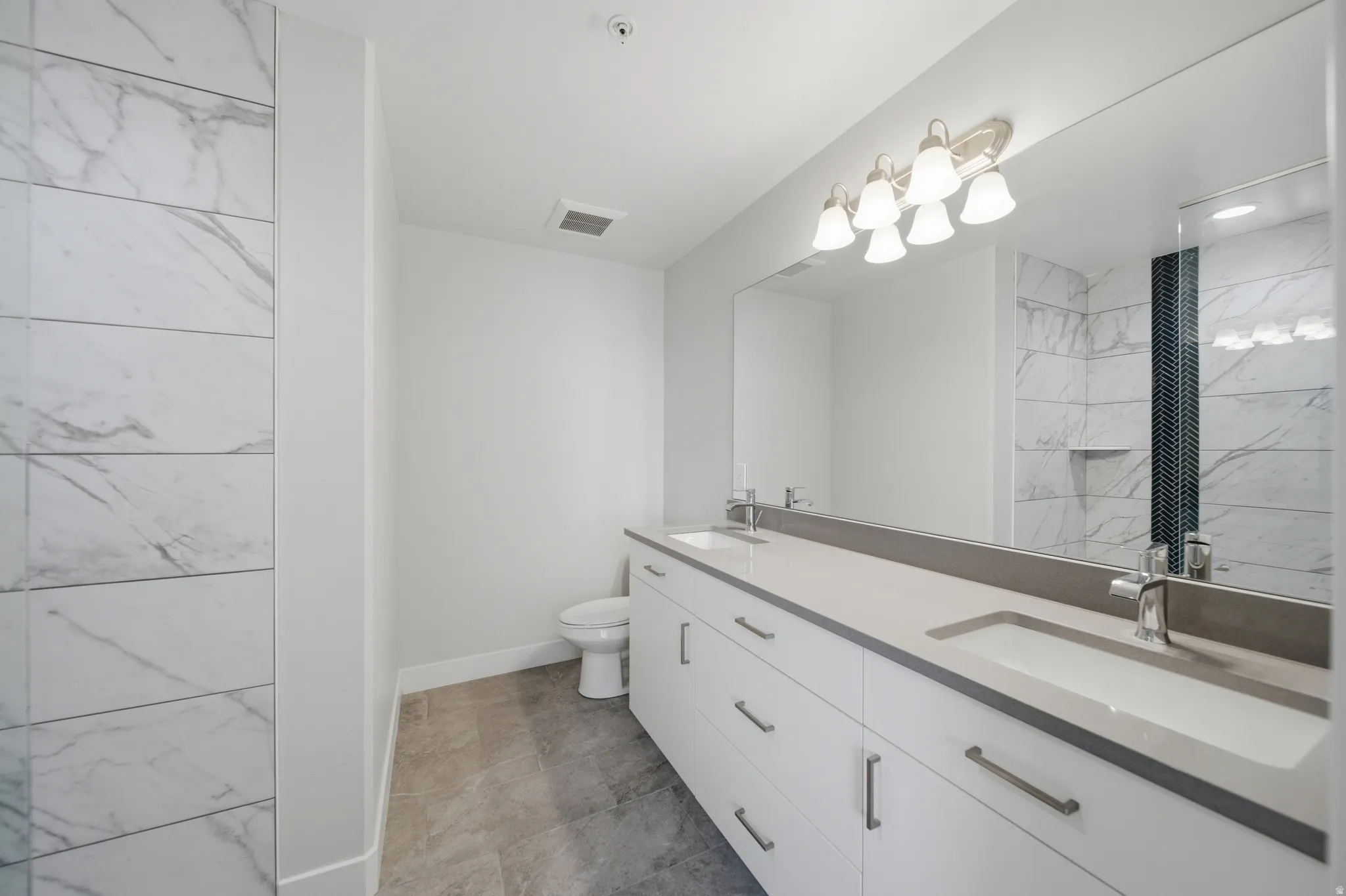 Dual vanity with integrated sinks and chrome fixtures