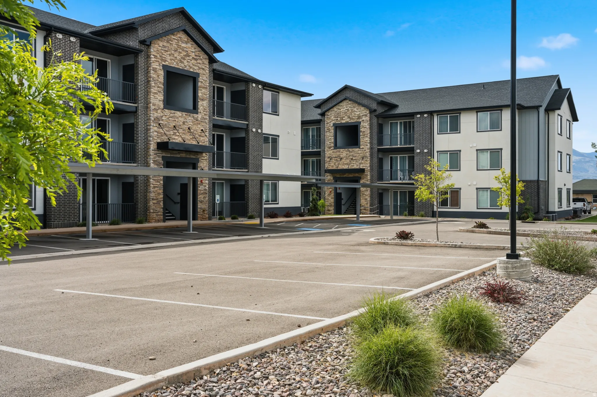 Contemporary multi-story building featuring stone and siding exterior accents