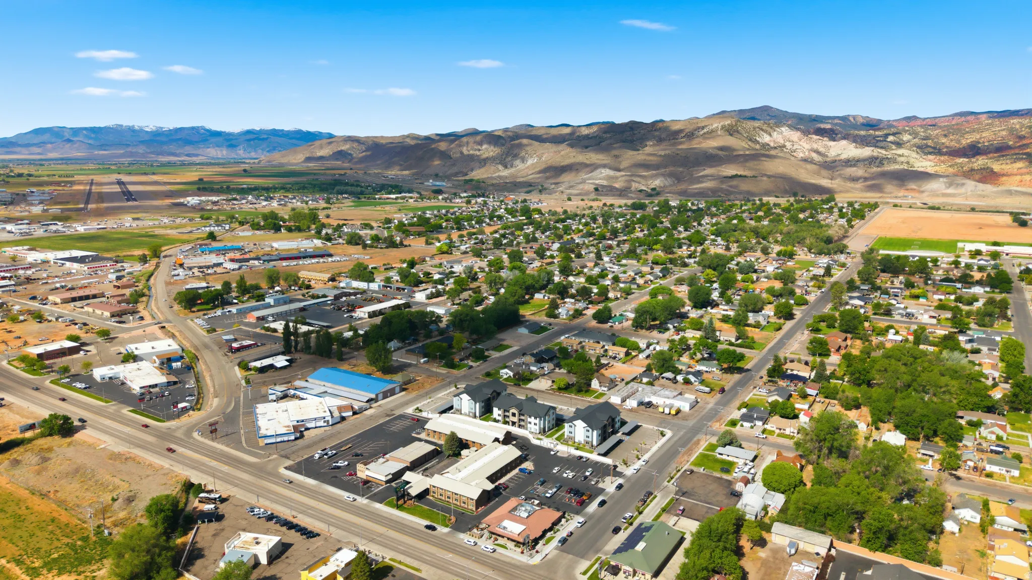 Aerial perspective showcasing a mixed-use community with residential areas and commercial establishments
