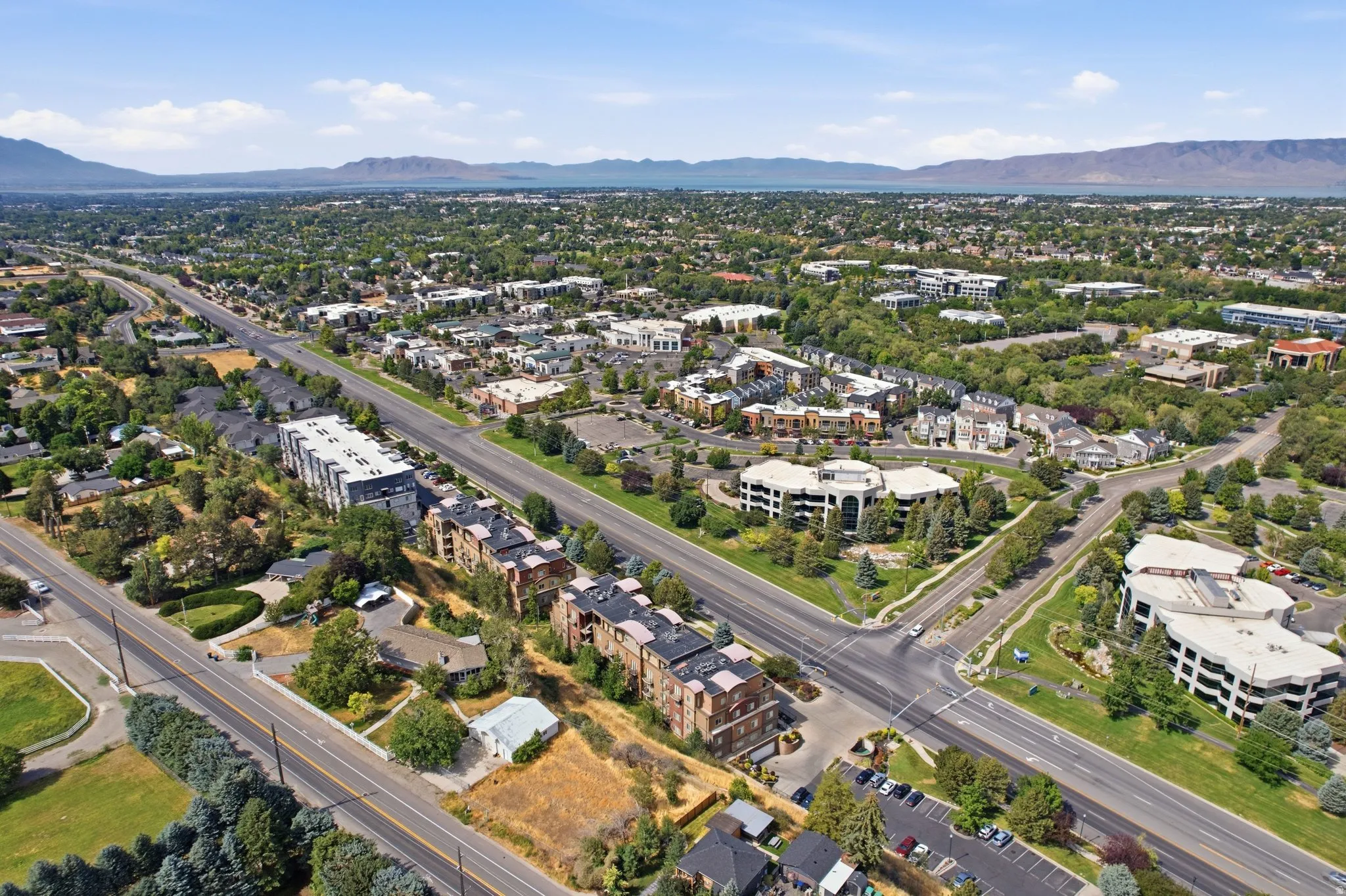 Expansive aerial perspective showcasing a developed urban landscape with diverse residential and commercial structures