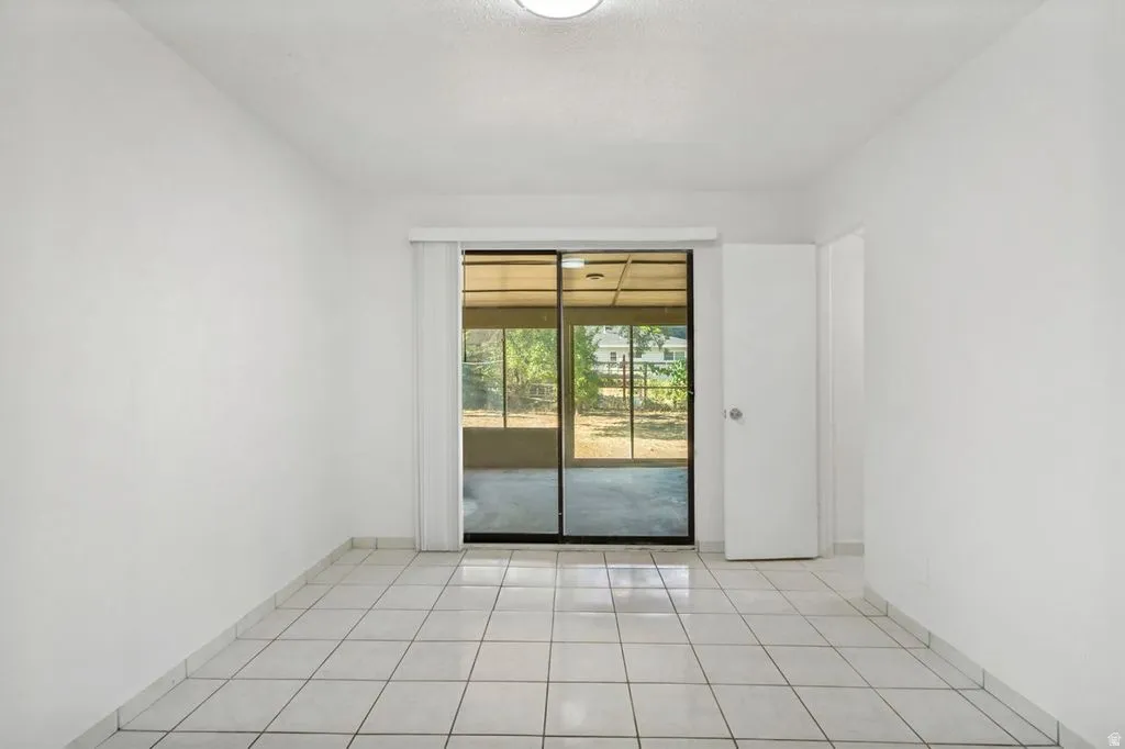 Bright interior space featuring white walls and square tile flooring