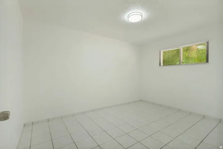 Light-filled interior featuring white walls and a white tile floor