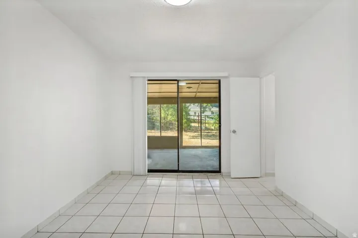 Bright interior space featuring white walls and square tile flooring