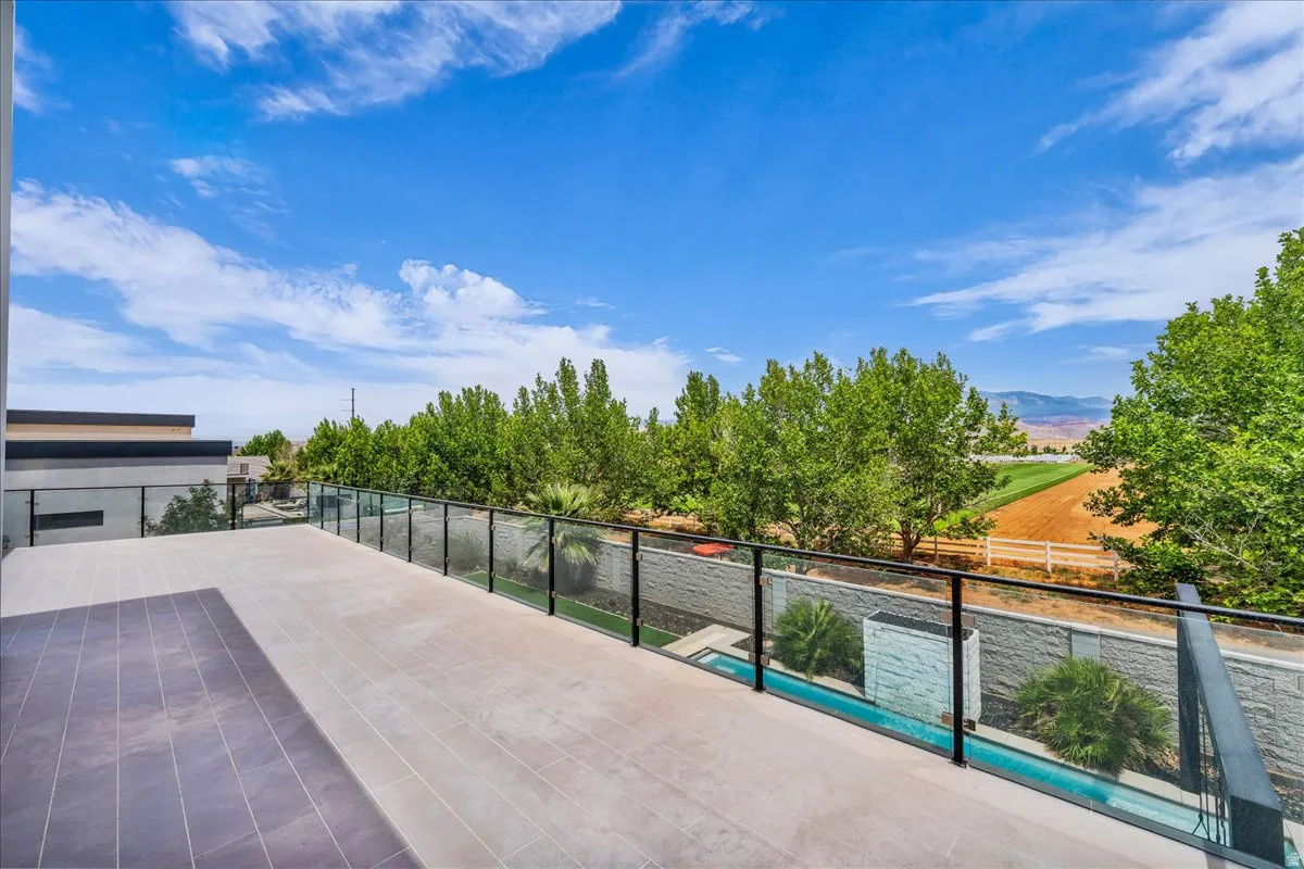 Expansive outdoor terrace featuring multi-tone tile flooring and a glass railing system