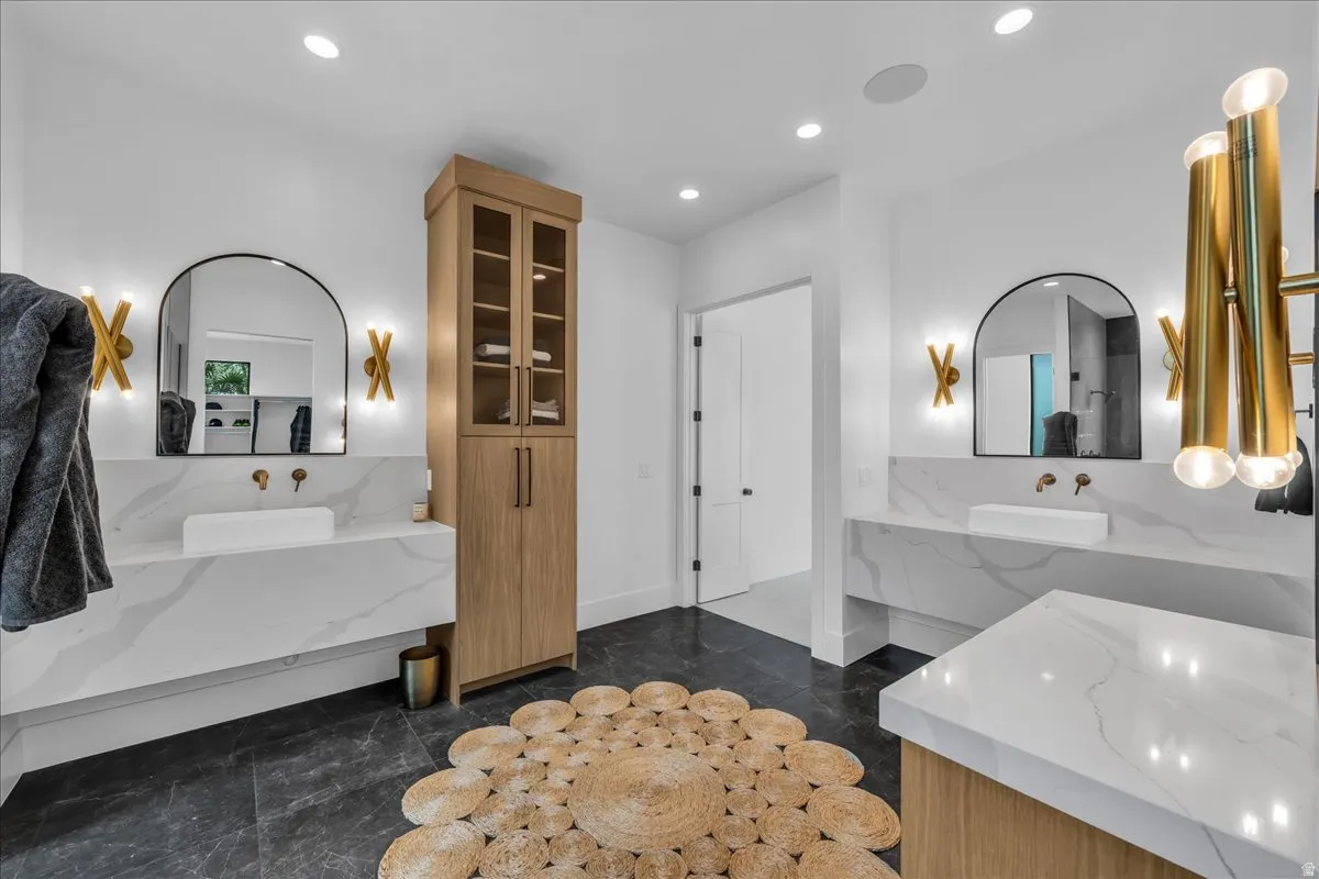 Spacious bathroom featuring two floating vanities with vessel sinks and integrated quartz countertops