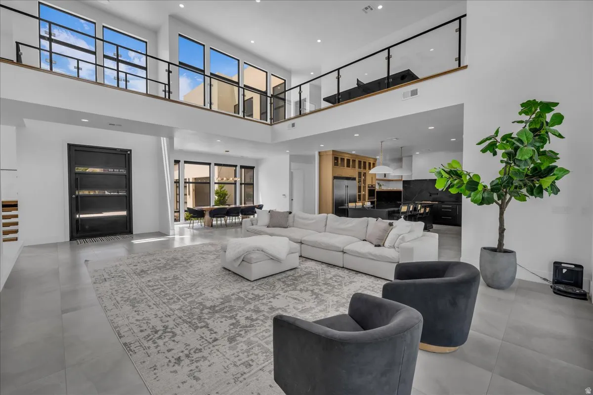 Open-concept living space featuring high ceilings and expansive windows