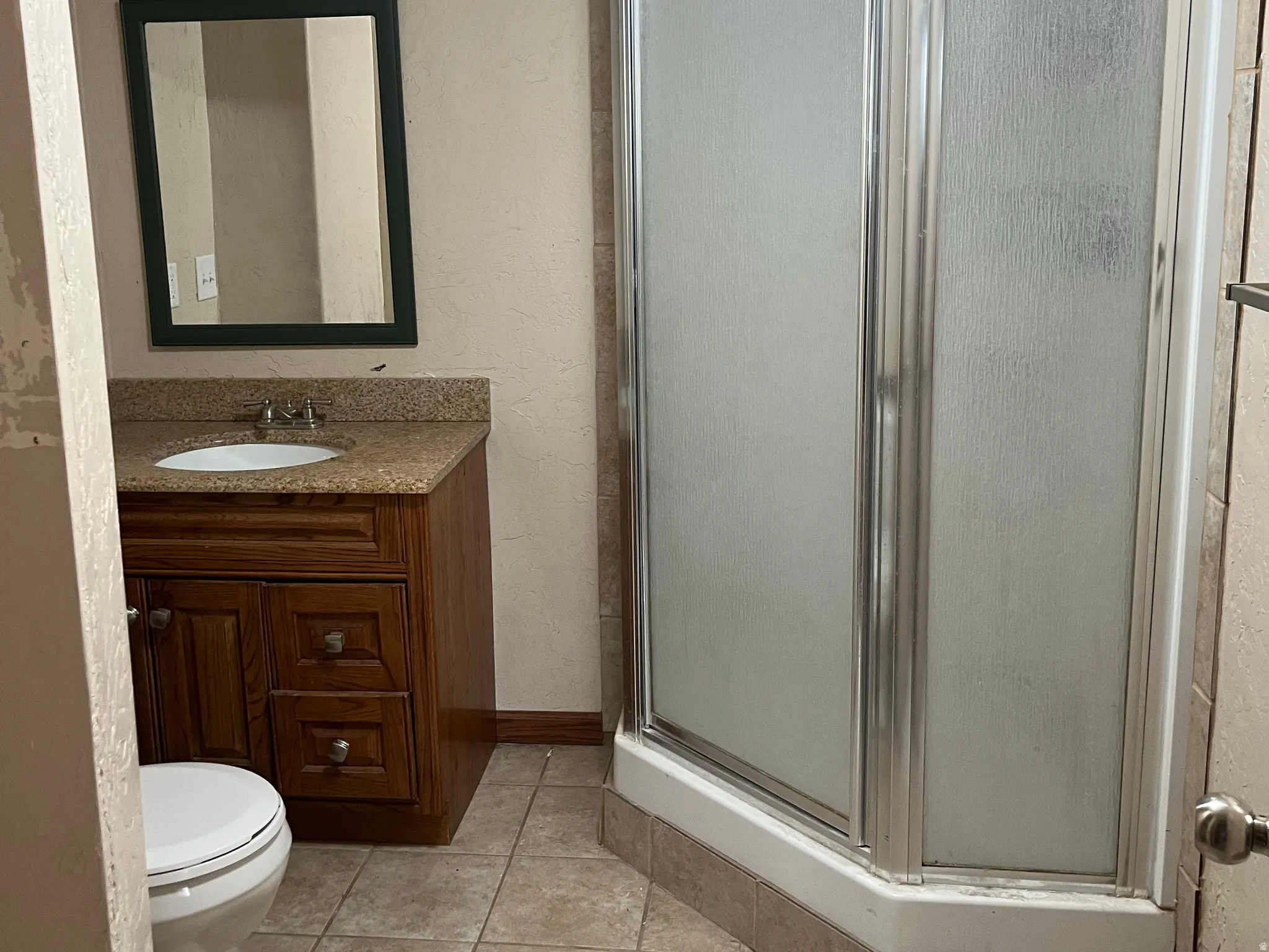 Bathroom with a shower. Located in the basement.