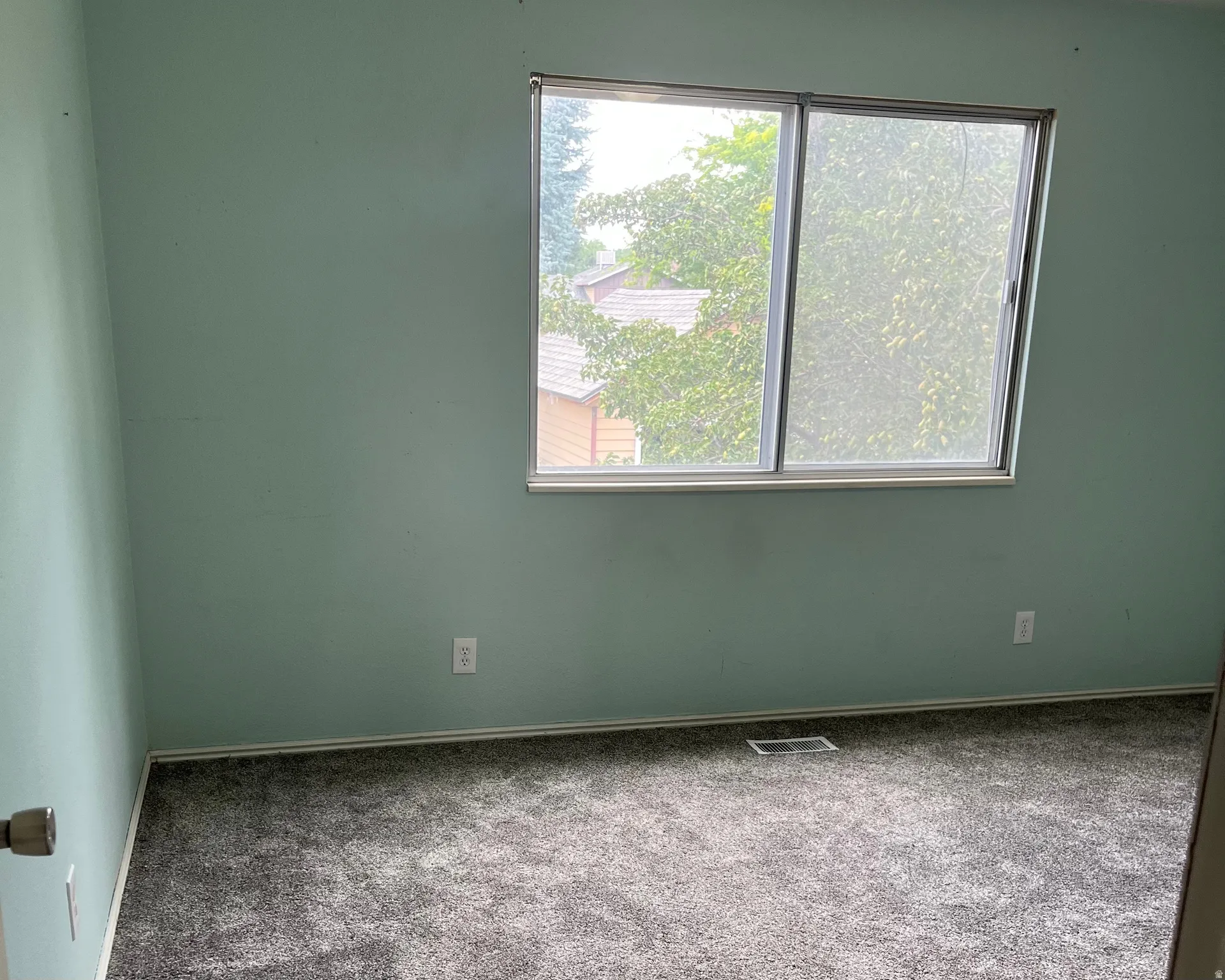 Newly carpeted master bedroom. Light green painted walls. Bedroom is 13.9' x 11.2'