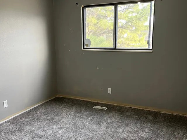 2nd bedroom upstairs. Needs baseboards.  New carpeting was recently installed.