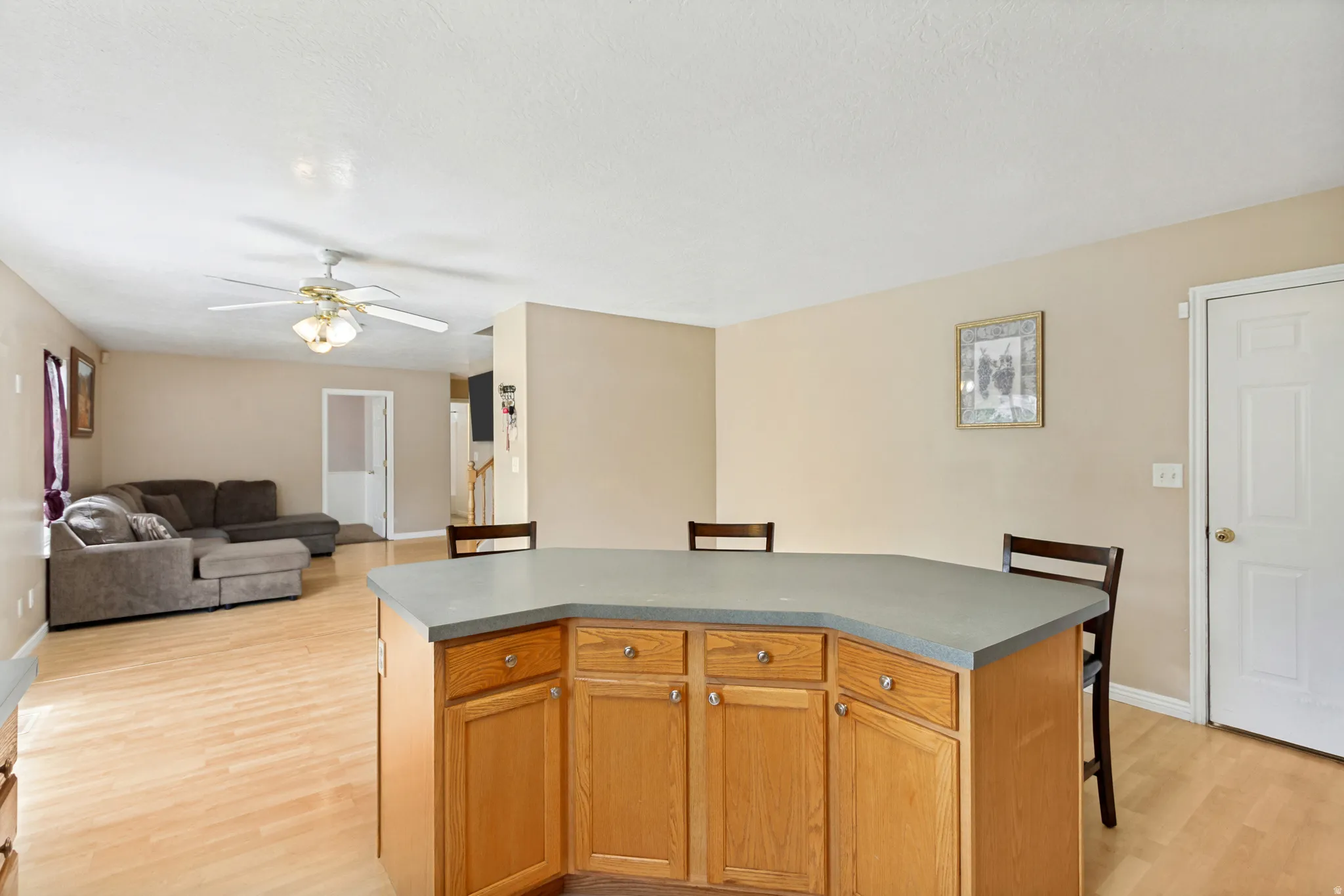 Kitchen island featuring wood cabinetry and a gray countertop