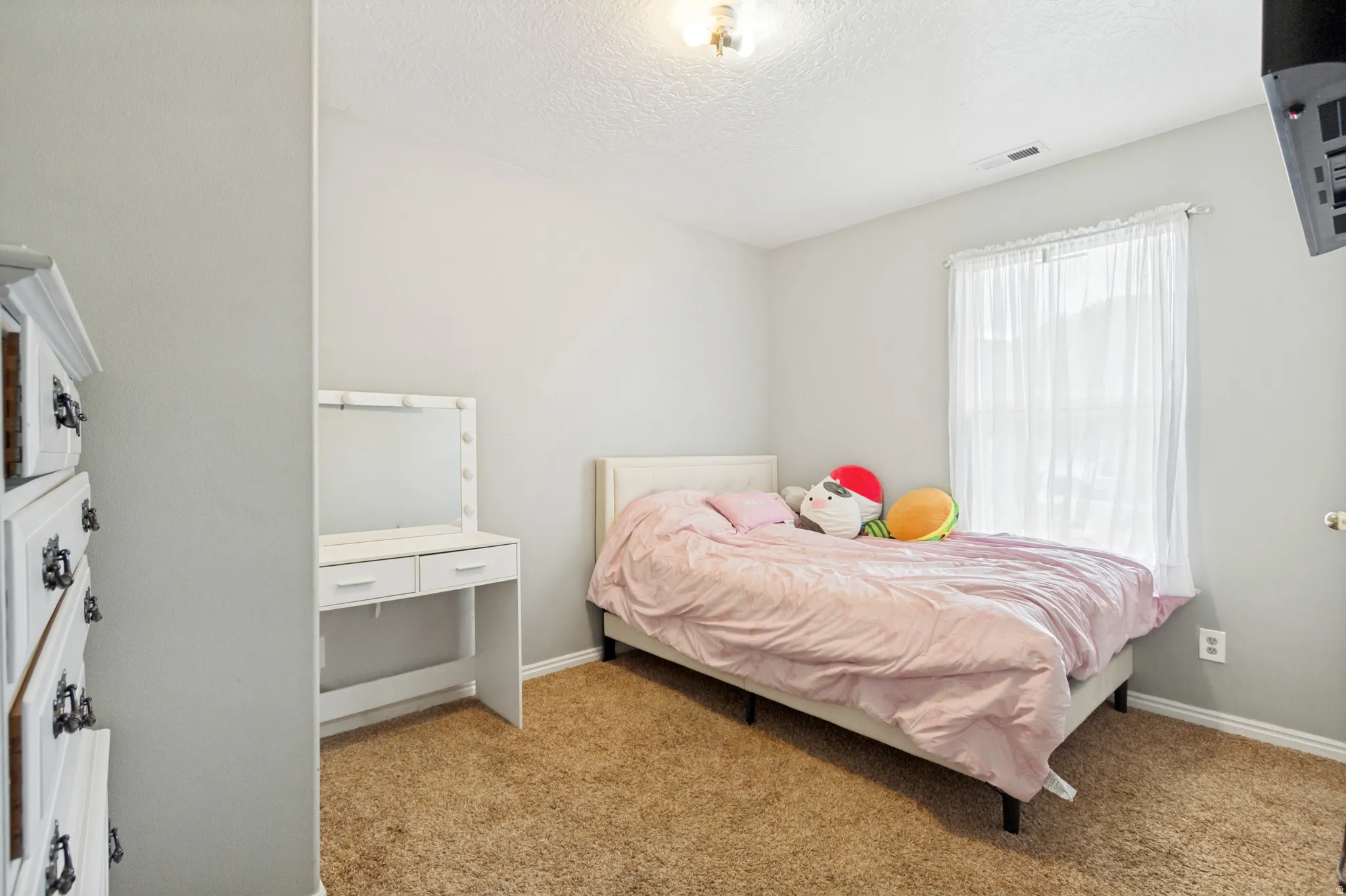 Plush brown carpeting, neutral wall paint, and white trim create a versatile interior