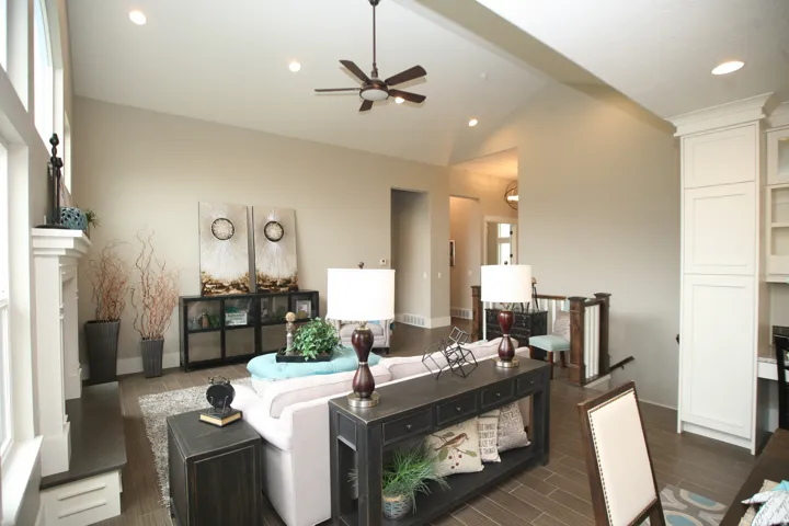 Vaulted ceilings with recessed lighting and a ceiling fan