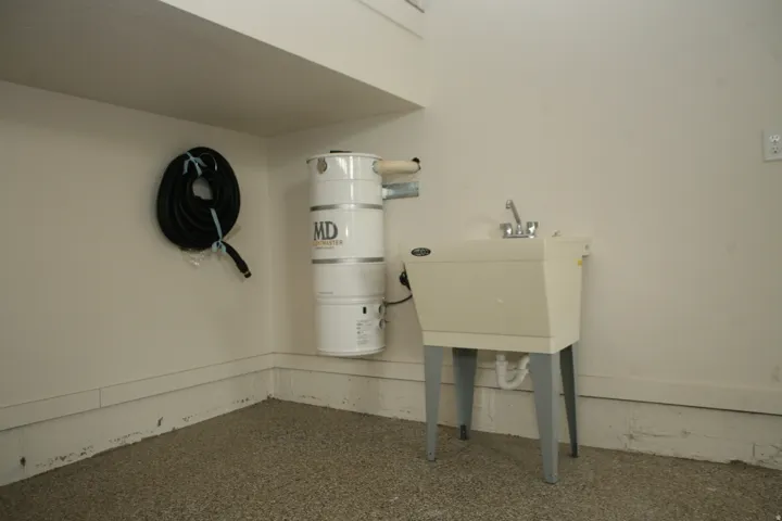 Utility sink with chrome faucet and central vacuum system, main garage off home.