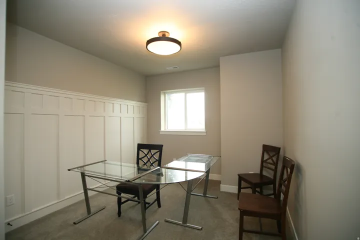 Room featuring white board and batten wall paneling, great for office or bedroom.