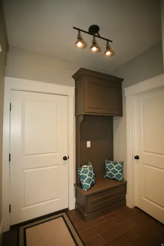 Custom built-in entryway bench with overhead cabinetry and beadboard backing