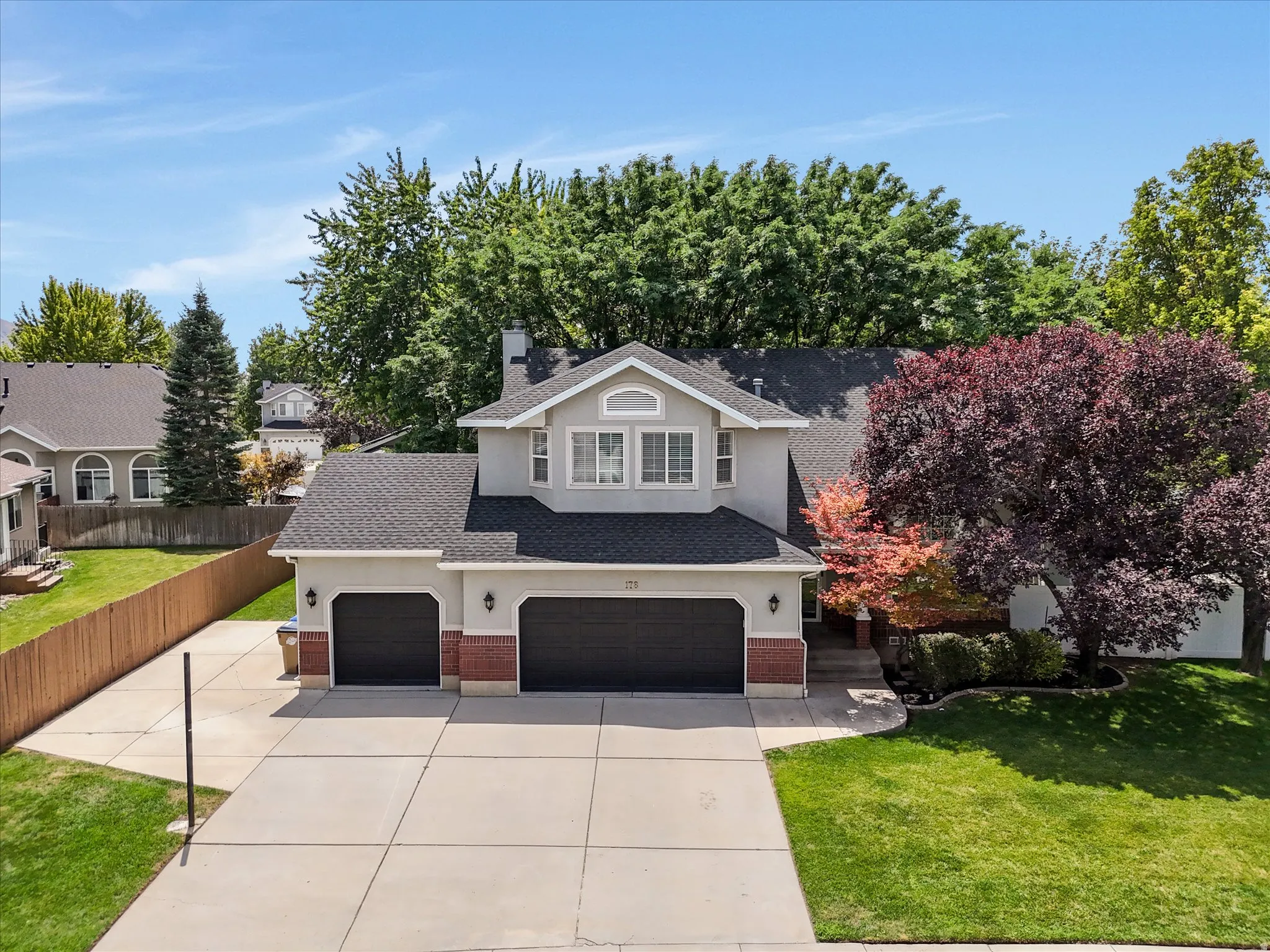 Stucco exterior with brick accents and a dormer window