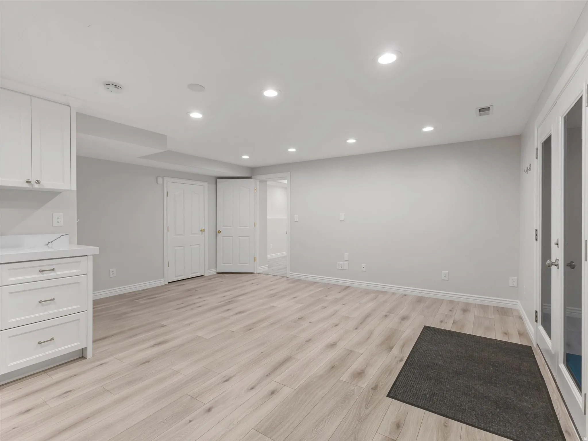 Spacious kitchen area ADU featuring wood-finish flooring, recessed lighting, and light-toned walls