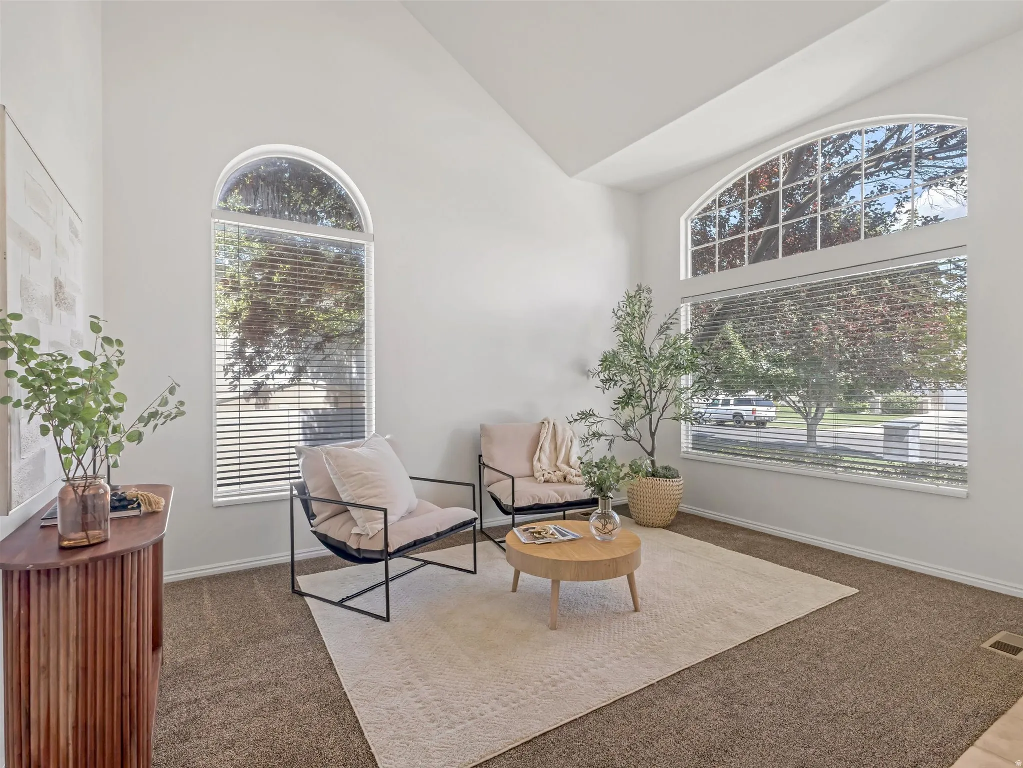 Front room.Vaulted ceilings enhance this space featuring expansive arched windows