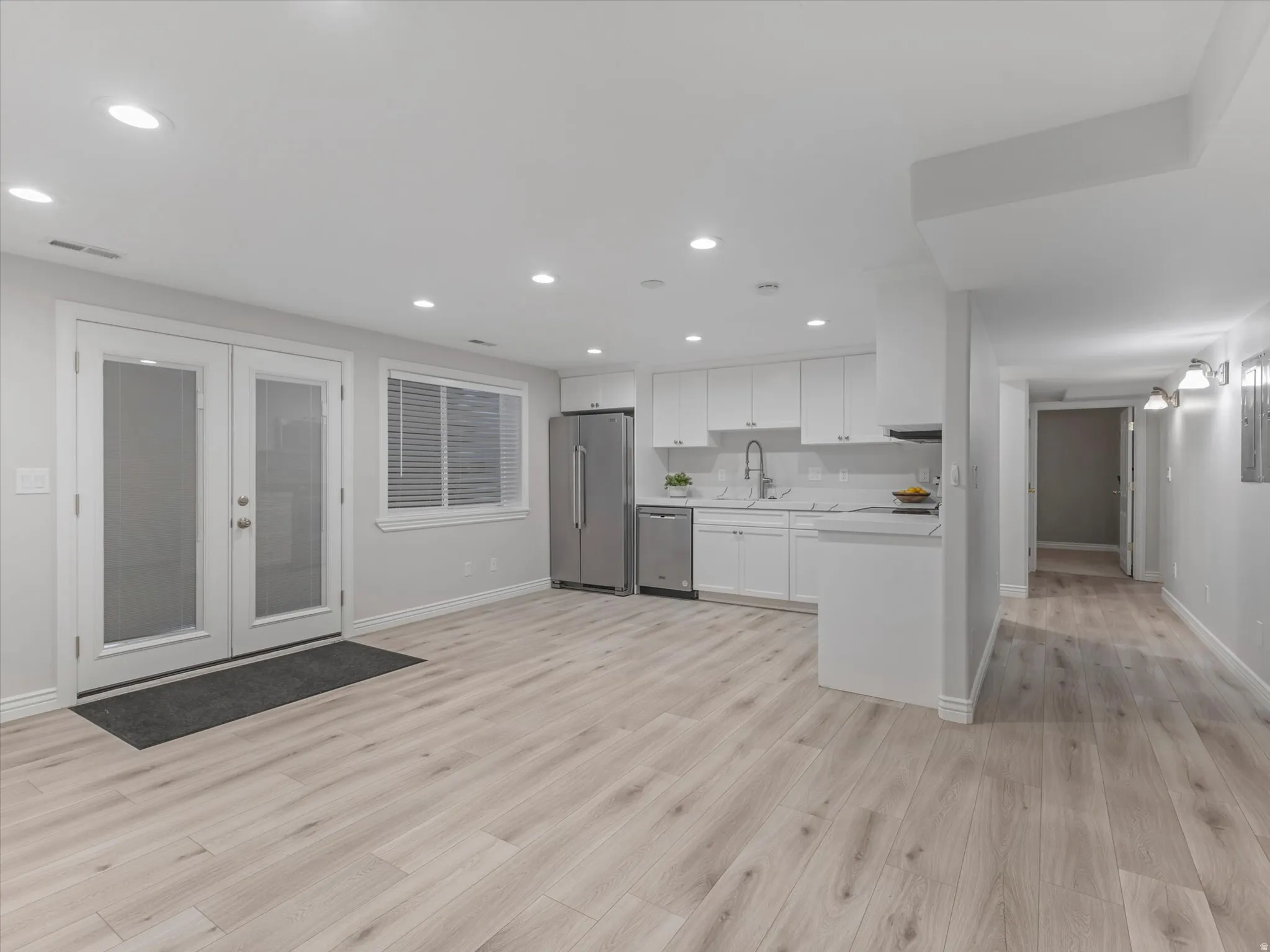 Spacious 2nd Kitchen area /ADU  open-concept area featuring light wood-finish flooring, recessed lighting, and a kitchen with white cabinetry