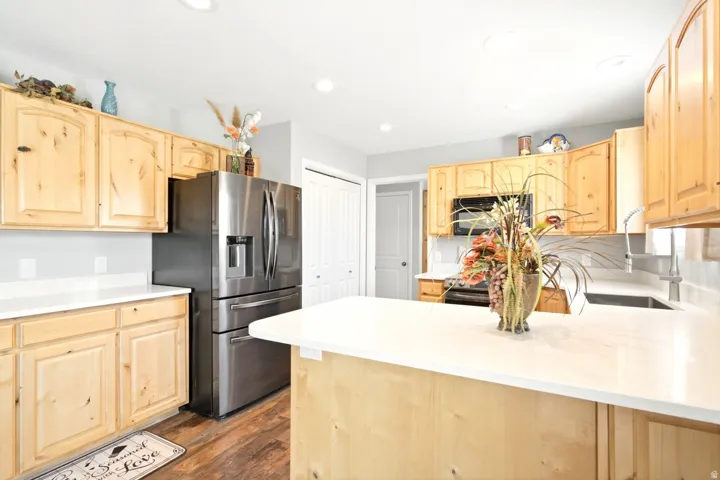 Bright kitchen featuring wood cabinetry and white countertops