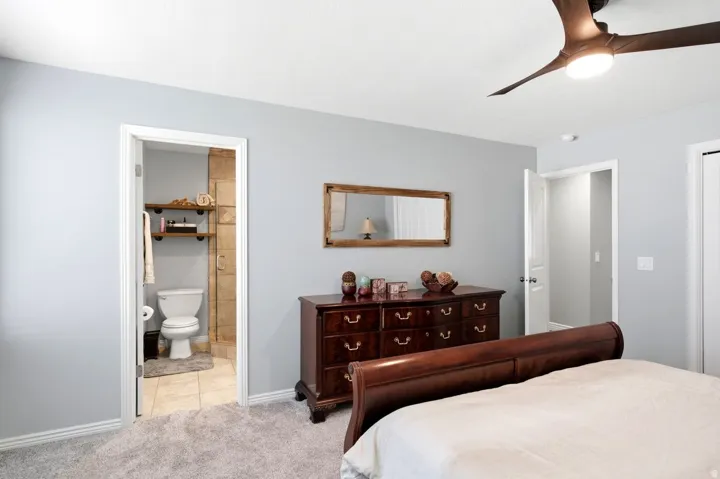 Bedroom featuring light gray walls and plush gray carpeting