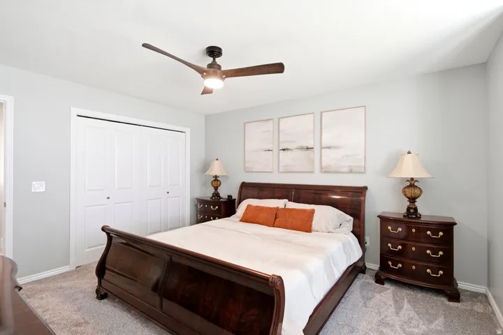 Bedroom featuring light gray walls and textured carpeting
