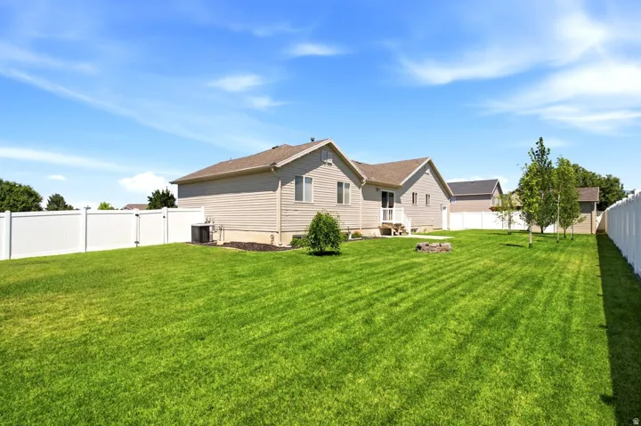 Spacious lawn area with vinyl privacy fencing