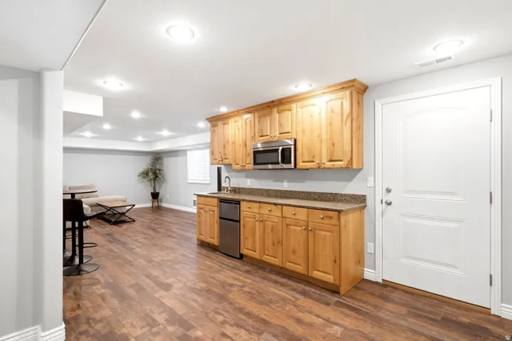 Entertainment space featuring wood-finish flooring, recessed lighting, and light gray walls