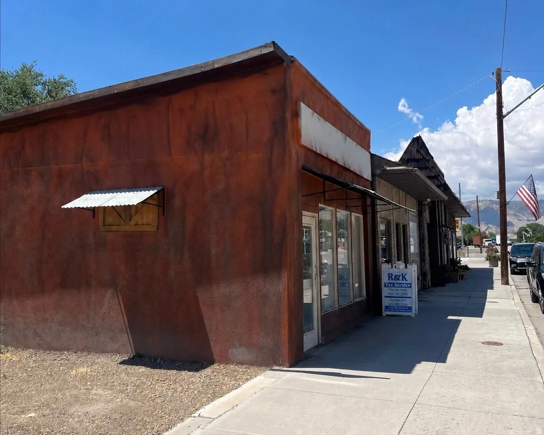 Commercial storefront featuring multiple large windows and a flat roofline