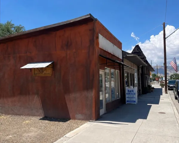 Commercial storefront featuring multiple large windows and a flat roofline