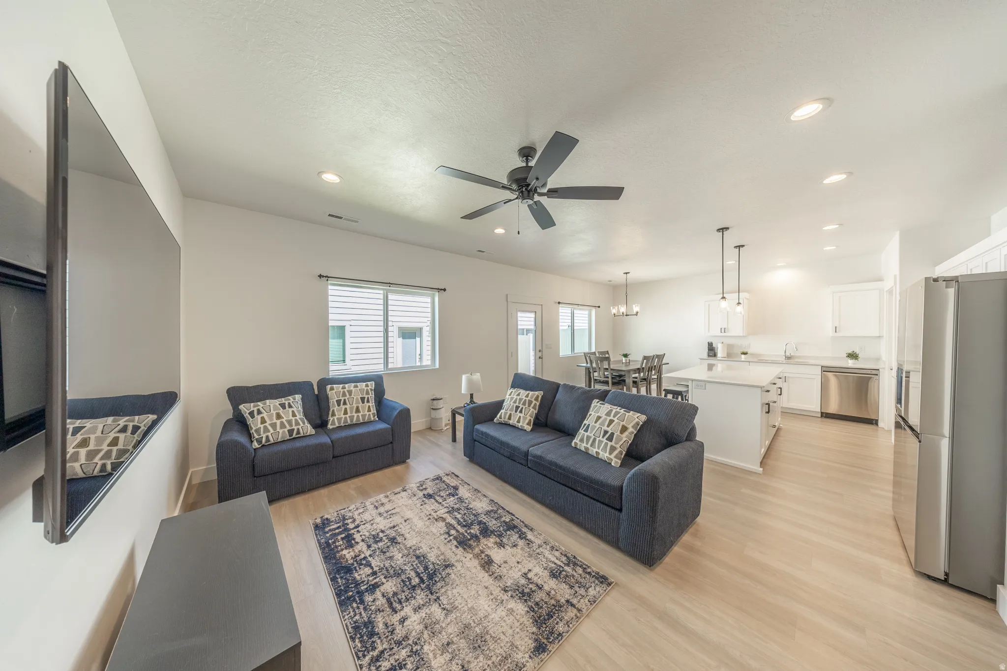Open-concept living space featuring wood-finish flooring throughout