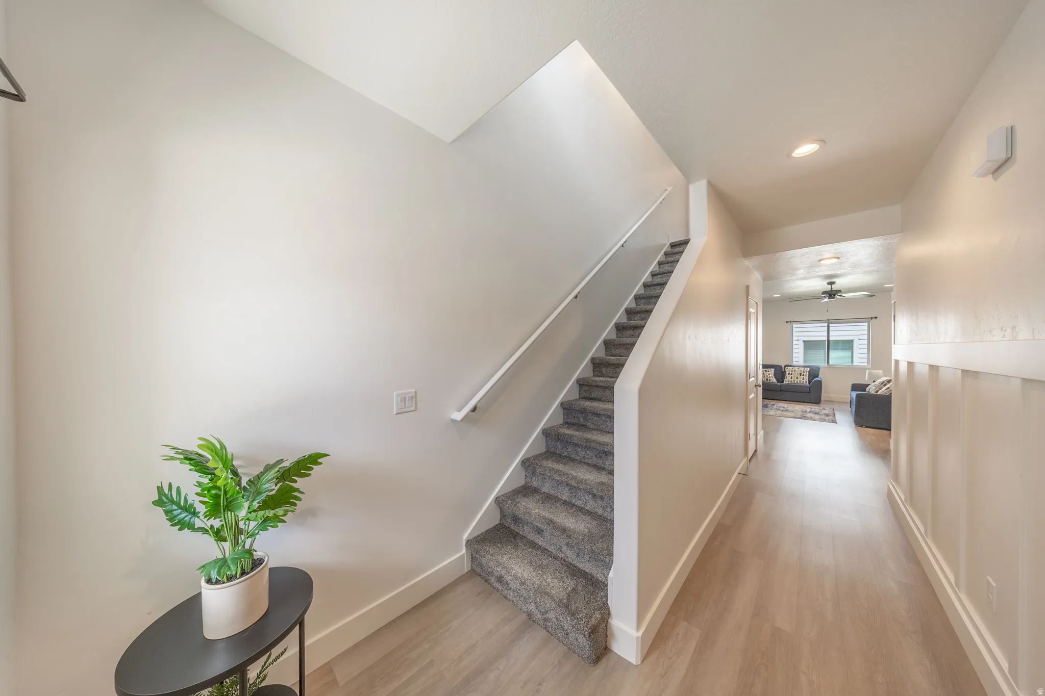 Entryway featuring light wood-finish flooring, recessed lighting, and white wainscoting