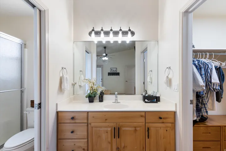 Light wood-finish vanity with a white countertop and integrated sink