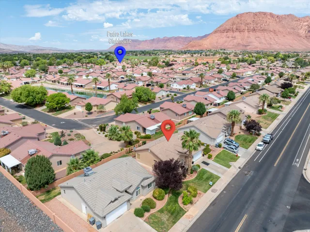 Aerial depiction of a residential neighborhood with a prominent red rock mountain backdrop
