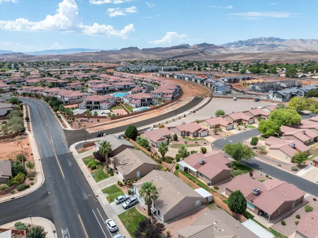 Expansive residential development featuring red tile roofs, paved roadways, and integrated landscaping