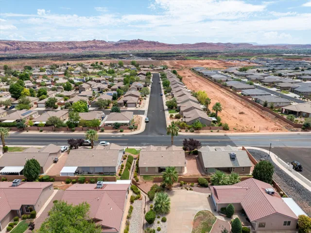 Aerial perspective showcasing a residential development with red rock mountain scenery