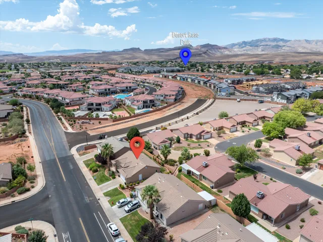 Aerial view showcasing a residential community with red rock mountain backdrops