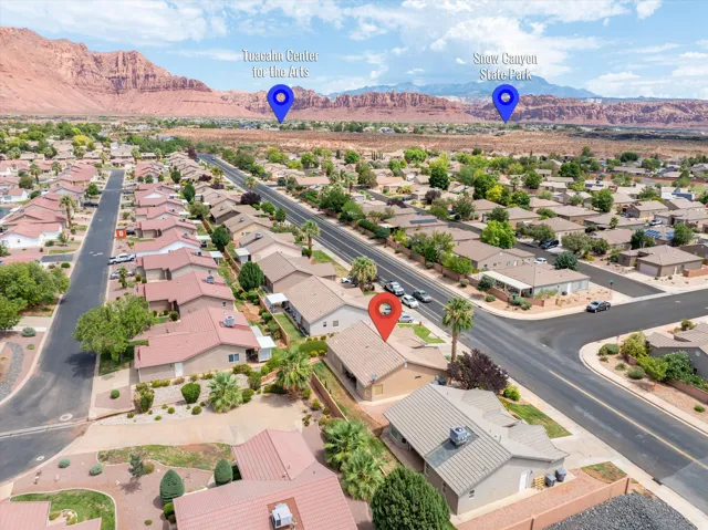 Aerial perspective of a residential neighborhood featuring single-story homes with tile roofs