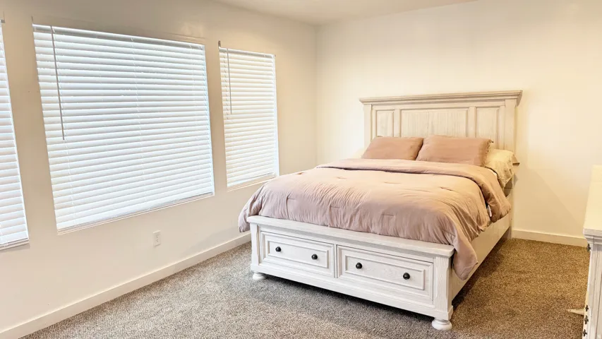 Neutral wall tones complement plush carpet flooring