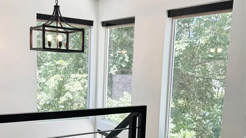 Modern chandelier with an open-frame design and exposed bulbs