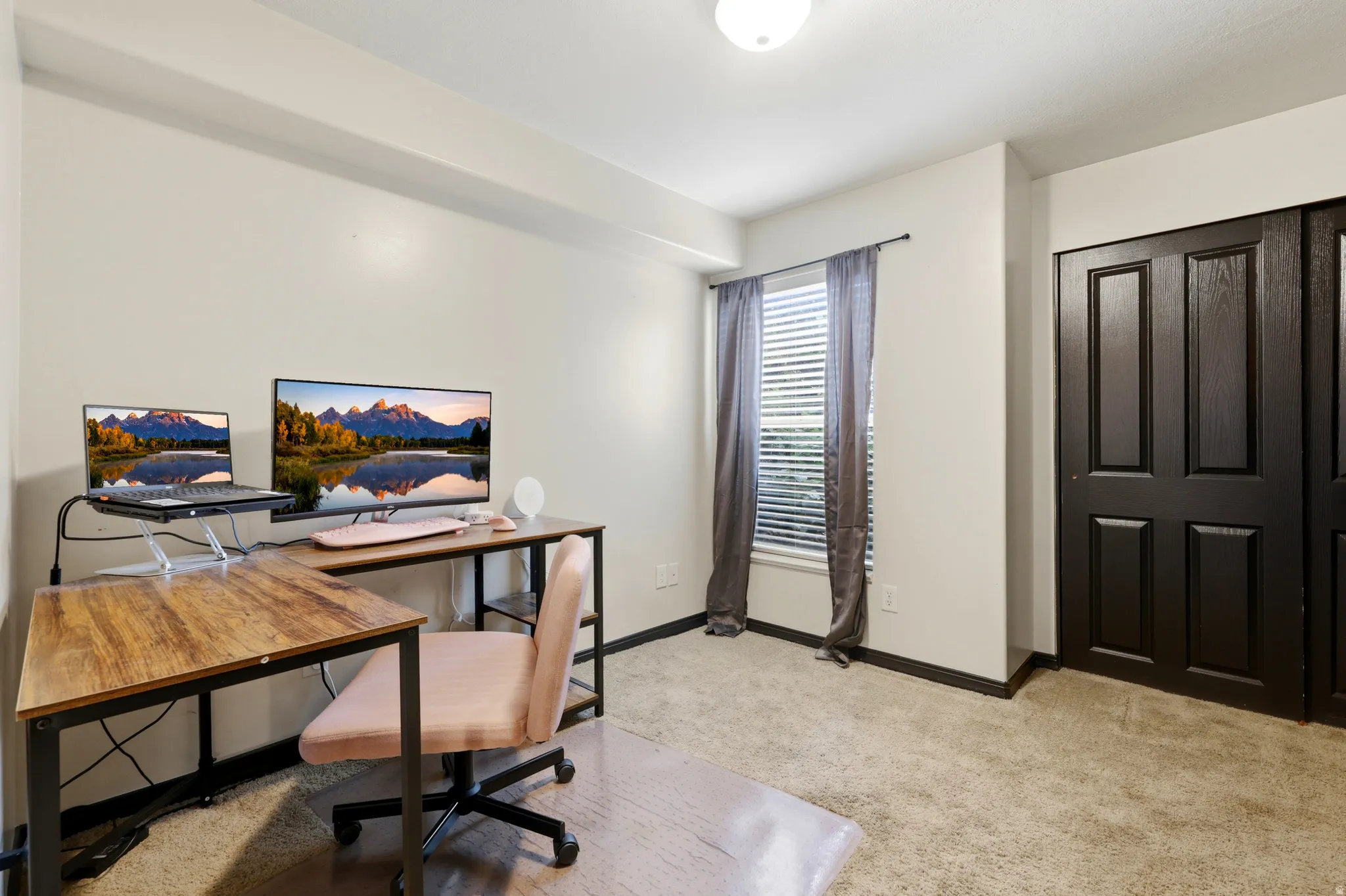 Neutral wall finishes with a ceiling-mounted light fixture